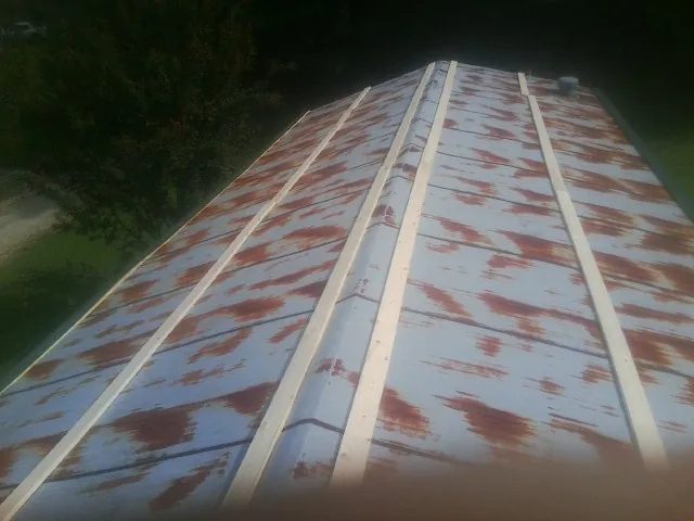 Rusted metal roof panels with new wood purlins before replacement — Storm Damage Roof Repair in Gold Beach by Roofing Brothers